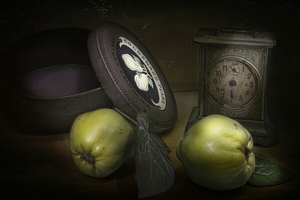 Still life vintage clock surrounded by apples