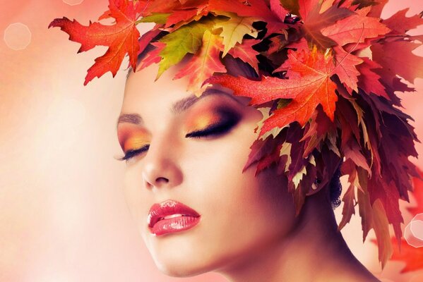 A girl with a wreath of autumn leaves