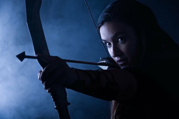 Beautiful girl with a bow and arrow