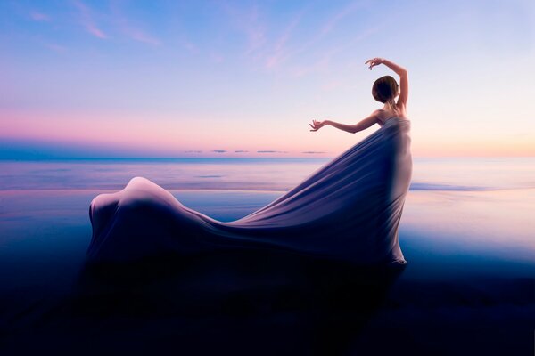 Una chica con un vestido volador en el horizonte