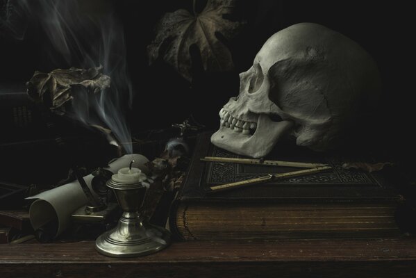 A skull and an extinguished candle on the table
