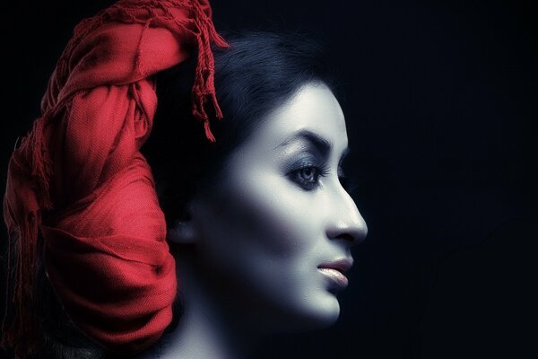 Portrait of a girl with makeup and a red headband on her hair