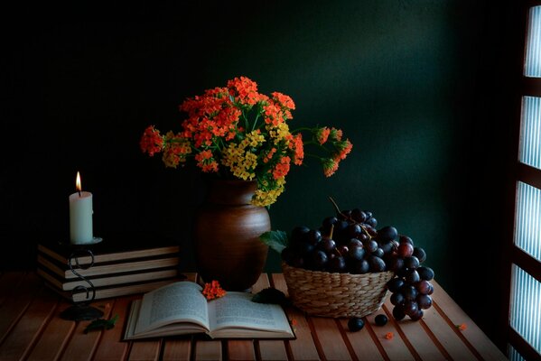 Still life flowers, grapes and books