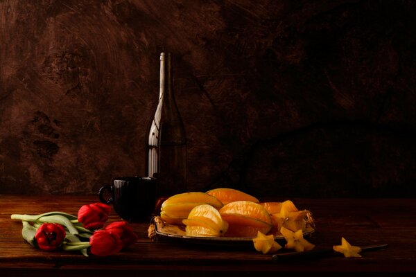 Original still life of carambola and tulips, very romantic