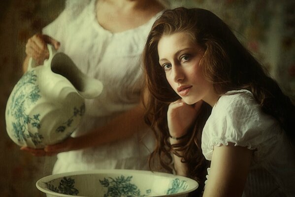 Vintage retro photo of a girl with a jug and a basin