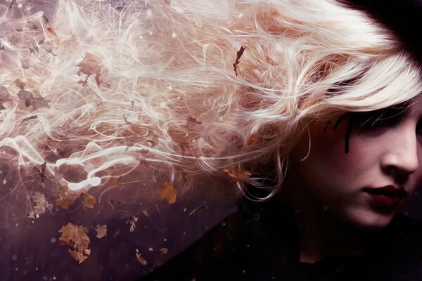 Portrait of a girl in a hat. whose hair is woven with smoke and autumn leaves