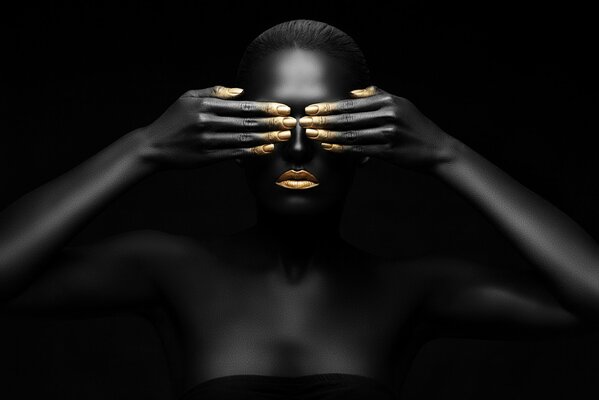 Black girl closes her eyes with gilded fingers