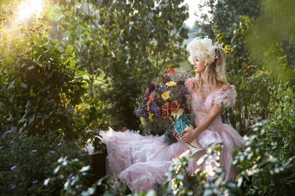 A girl is sitting in nature with flowers