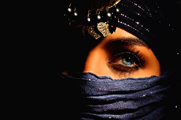 Oriental girl in a headscarf with blue eyes