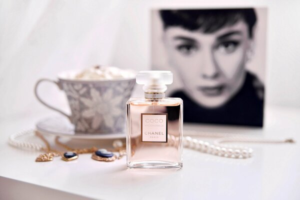 Chanel coco mademoiselle on the background of a cup