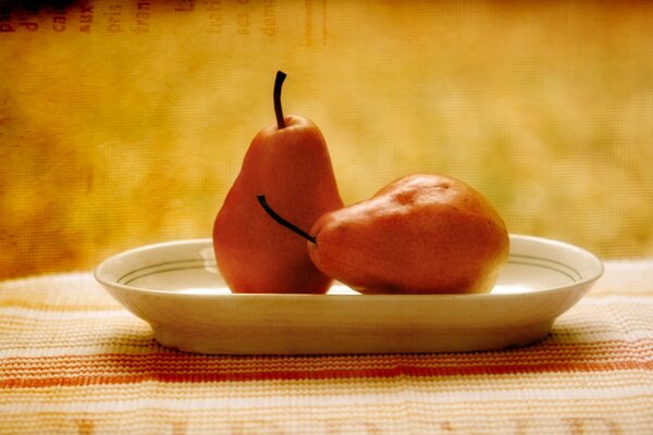 Two pears on a golden background