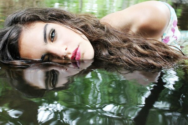 Reflection of a girl in the water surface