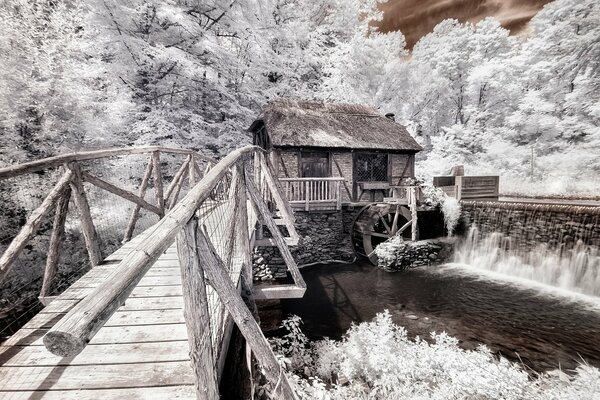 Winter landscape with a house across the bridge