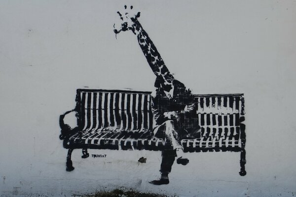 A black and white giraffe is sitting on a bench