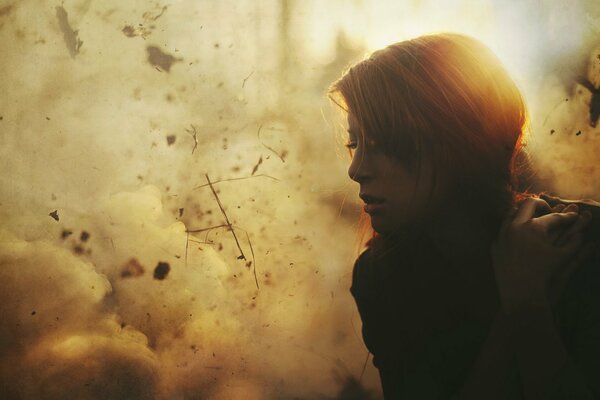 A girl against a background of sunlit smoke