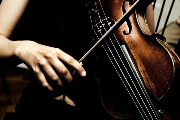 A girl plays an old violin