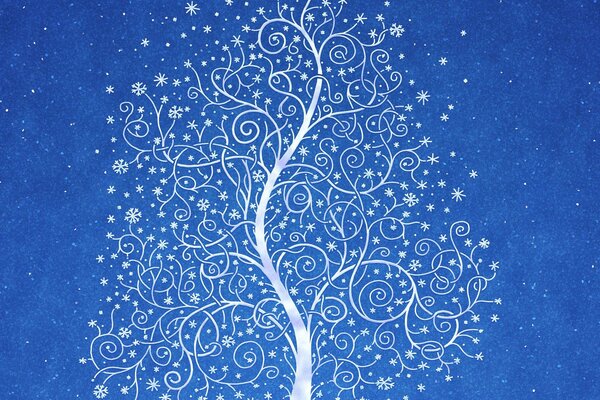 Дерево в снежном узоре на фоне синего неба