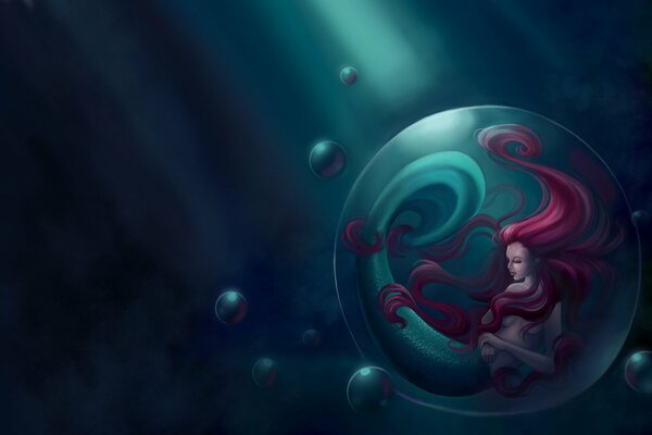 A mermaid with red hair in a bubble at the bottom of the sea