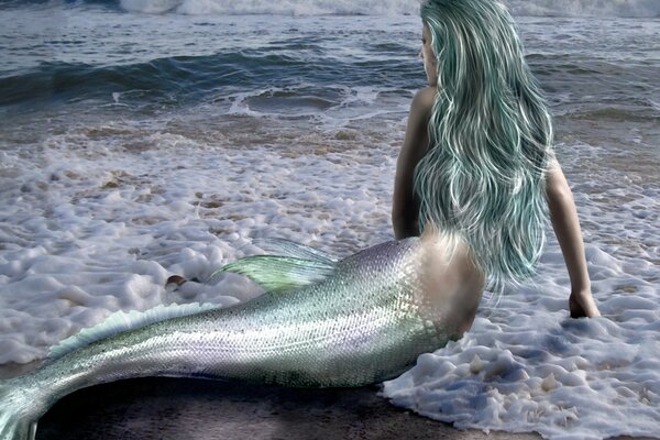 Fantasy image of a long-haired mermaid on the shore