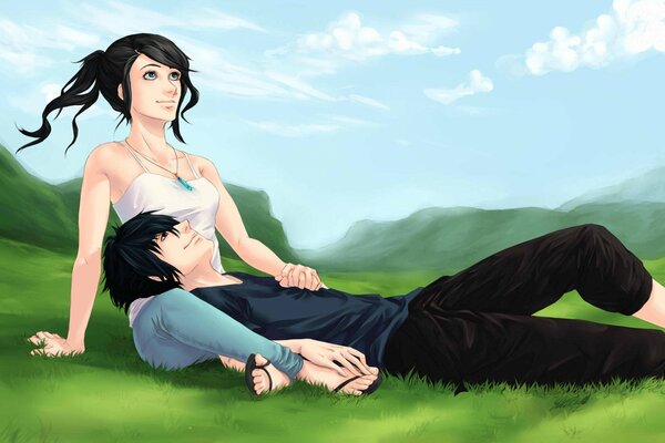 A girl and a guy relax on the grass