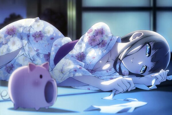 A girl in a kimono is lying on the floor