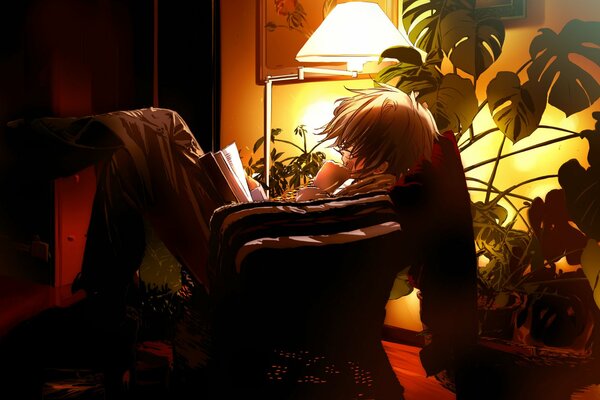 Le gars de l anime lit un livre dans la soirée sur une chaise