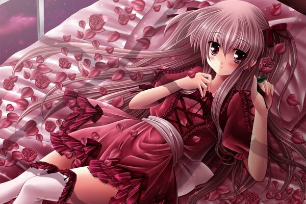 A girl in red lies on pink petals