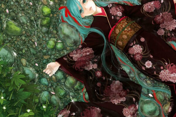 A girl in a kimono lies on green stones