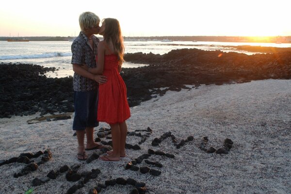 A kiss on the beach by the sea