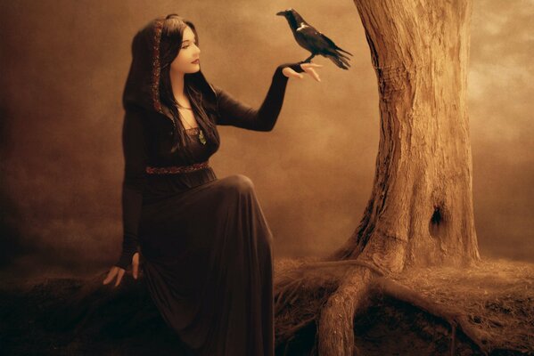 A witch with a raven in the night forest