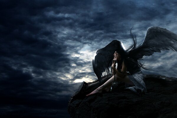 On a black and gray background, the image of a black angel girl