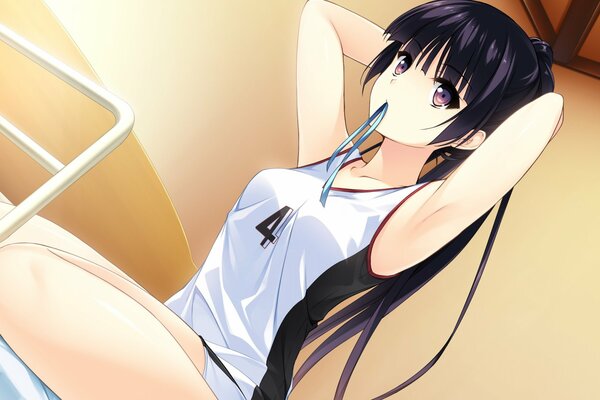 A girl in a sports uniform is sitting with a ribbon in her mouth