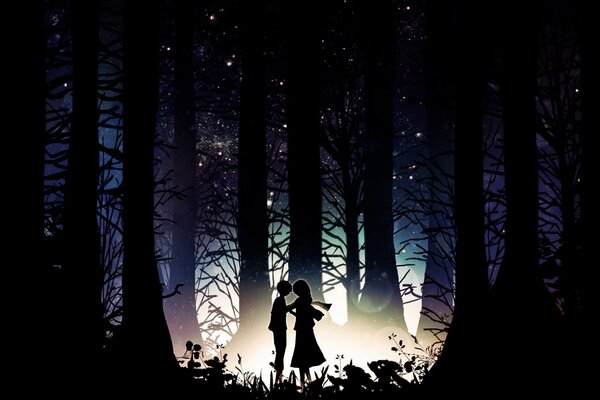 Silhouette of a couple at night among trees and grass