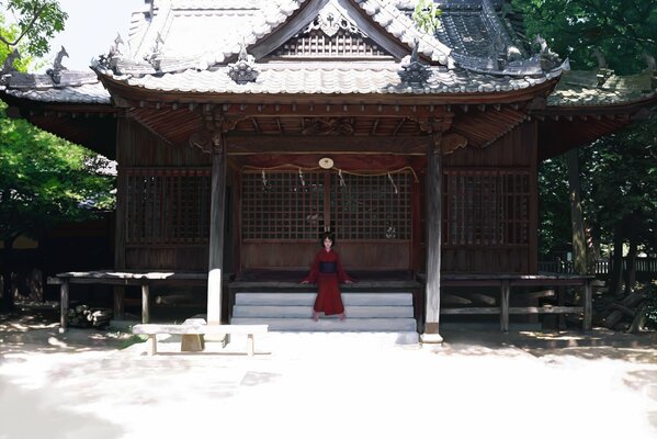 A girl in a red kimono on the steps