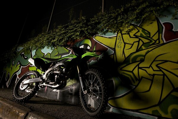 Kawasaki on the background of graffiti at night