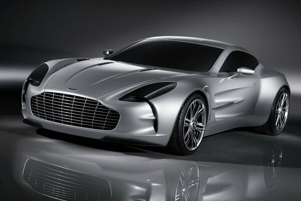 The legendary silver Aston Martin is reflected in the mirrored floor