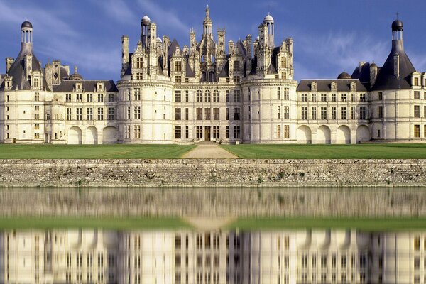 Beautiful white castle reflected in the water