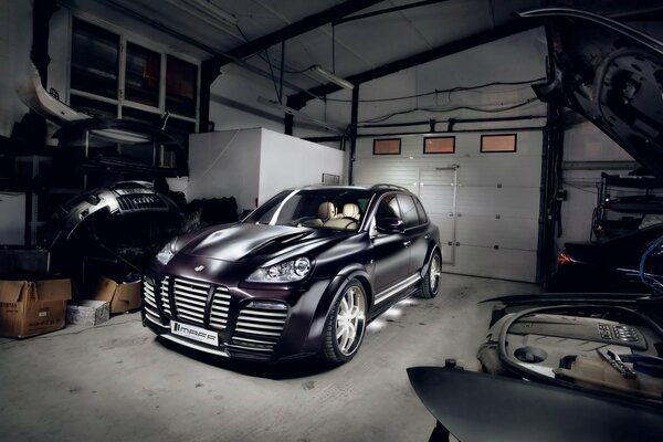 The Porsche Cayenne car is in the garage