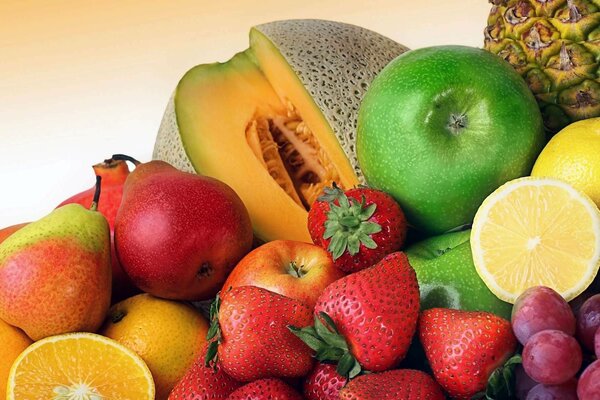 Assorted fruit: strawberries, lemon, grapes, pears, oranges, apples, passion fruit