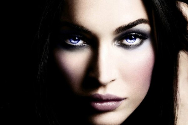 Megan Fox looks out of the dark