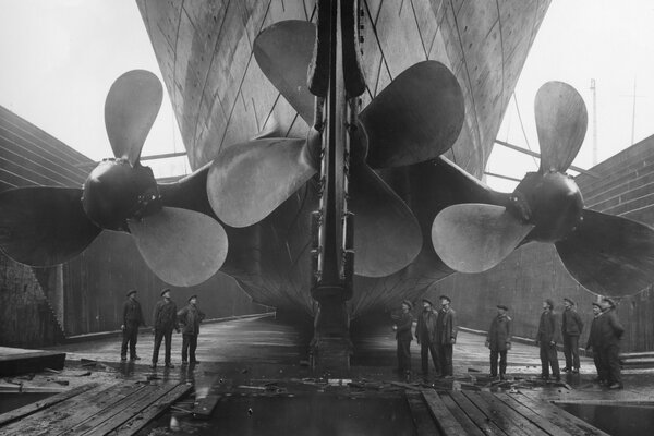 People look at the Titanic s large ship propellers