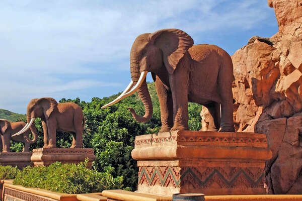 Brown elephant statues on pedestals