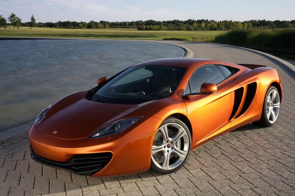 Orange mclaren standing on the tile