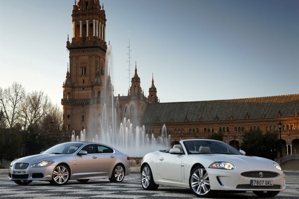 Two convertible sedan on the background of the castle