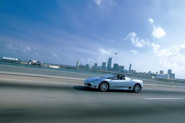 Blue sky , the highway on which the car is racing