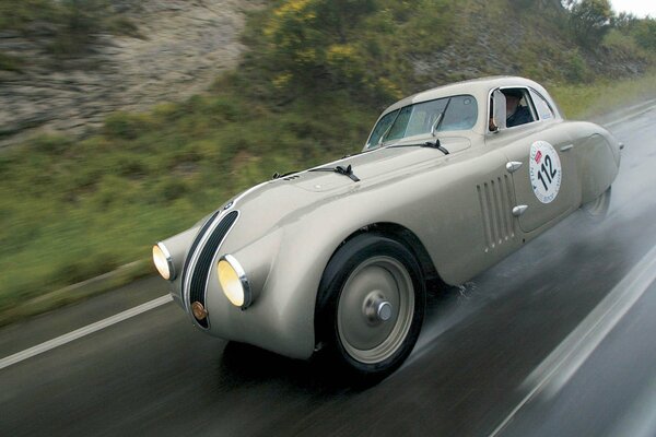 Classic BMW sports car rides in rainy weather