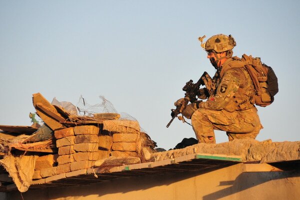 A soldier holds a weapon in his hand