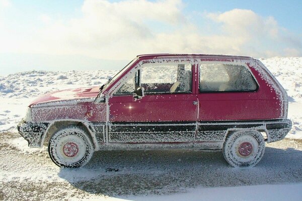 A car covered with snow on the bank of the Oka