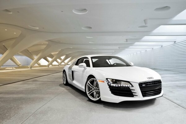 White Audi under a canopy in the building