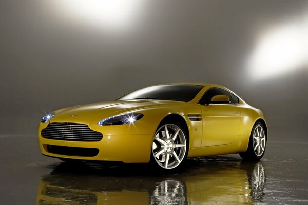 Yellow aston martin v8 car. Mirror image on the floor